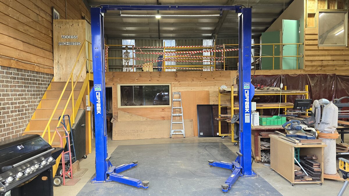 The two-post car hoist at the shed
