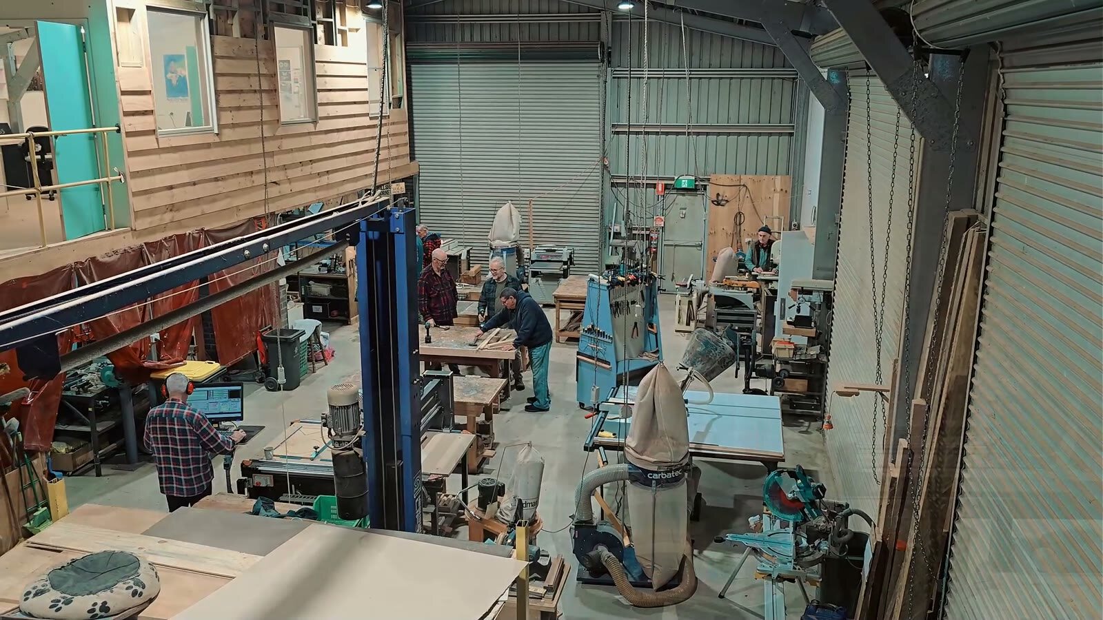 A view across the Bright United Men's Shed workshop, with members at the benches